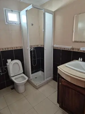 a bathroom with a shower and a toilet and a sink at Appartement atlas fes 5 in Fès