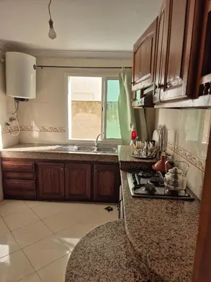 a kitchen with a stove and a sink and a window at Appartement atlas fes 5 in Fès