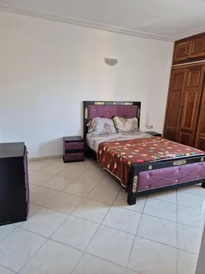 a bedroom with a purple bed in a room at Appartement atlas fes 5 in Fès