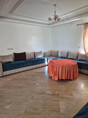 a living room with a couch and a table at Appartement atlas fes 5 in Fès