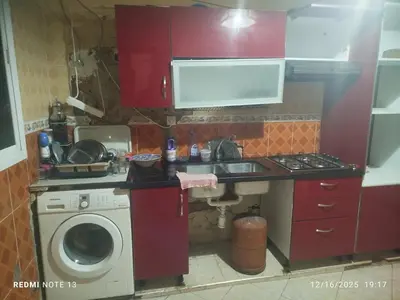 a kitchen with a sink and a washing machine at Otmania house Meknès in Meknès