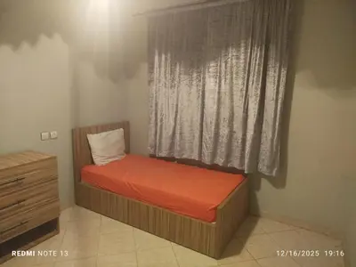a small bed in a room with a window at Otmania house Meknès in Meknès