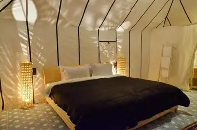 a bedroom with a large bed in a tent at Désert camp berbère Sahara in Merzouga