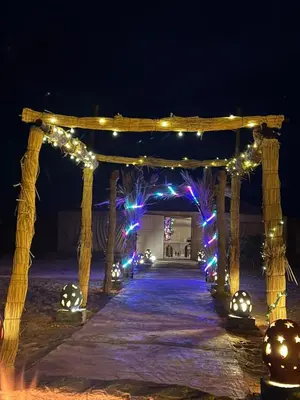 a wooden arch with christmas lights on it at Désert camp berbère Sahara in Merzouga