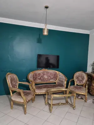 a living room with a table and two chairs and a tv at 5 min from the field in Fès