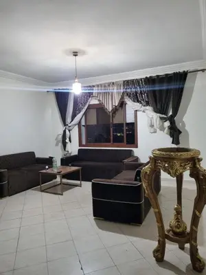a living room with couches and a window at 5 min from the field in Fès