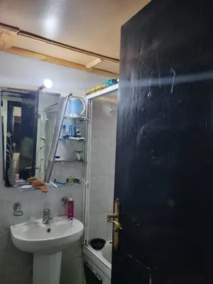 a bathroom with a sink and a toilet and a mirror at 5 min from the field in Fès