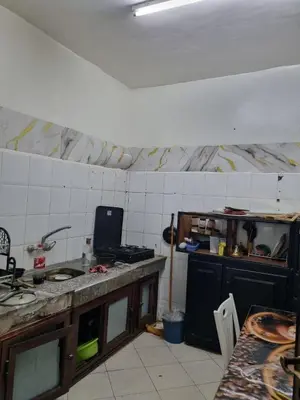 a kitchen with a table and a counter top at 5 min from the field in Fès