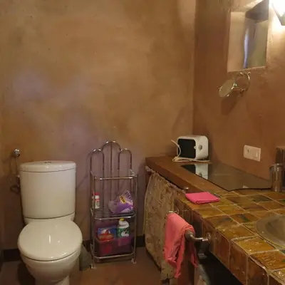 a bathroom with a toilet and a sink at Jnan Ksar el Kdim - Studios Safran, Jasmin et Cannelle in Mhamid