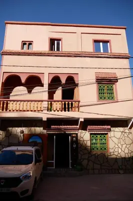 a white car parked in front of a building at La Belle étoile in Aït Oussane