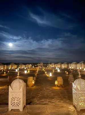 a row of lights in a courtyard at night at Fabulous Royal Camp in Merzouga