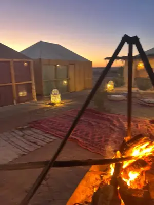 a view of a tent with a fire in front of it at Fabulous Royal Camp in Merzouga