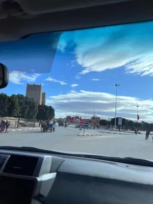 a view of a parking lot from a car window at Fabulous Royal Camp in Merzouga