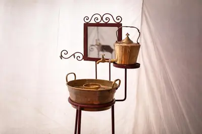 a tarnished copper bucket and mirror on a stand at Star Dunes in Mhamid