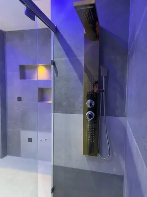 a shower with a glass door in a bathroom at Haut standing apartment in hearth of fez in Fès
