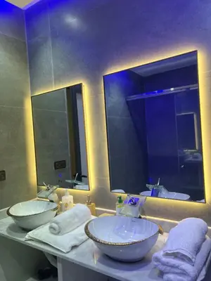 a bathroom with two sinks and a large mirror at Haut standing apartment in hearth of fez in Fès