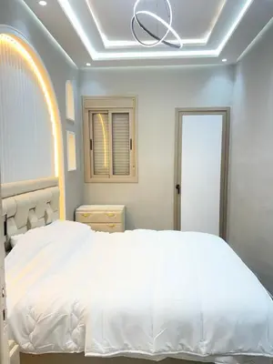 a bedroom with a white bed and a ceiling at Haut standing apartment in hearth of fez in Fès