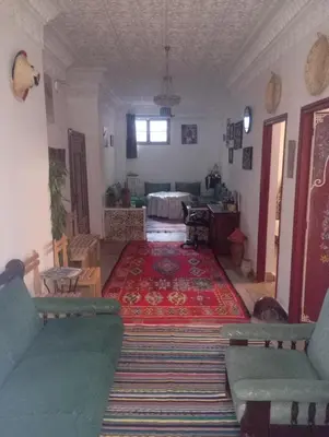 a living room with a couch and a rug at Dar al mardi fes luxury in Fès