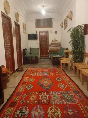 a living room with a red rug on the floor at Dar al mardi fes luxury in Fès