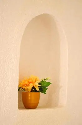 a orange flower in a pot in a wall at Dar al mardi fes luxury in Fès