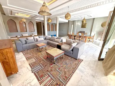 a living room with a couch and a table at Luxury Villa with Private XXL Pool in Azib Oulad Lâdem