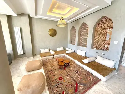 a living room with a couch and a table at Luxury Villa with Private XXL Pool in Azib Oulad Lâdem