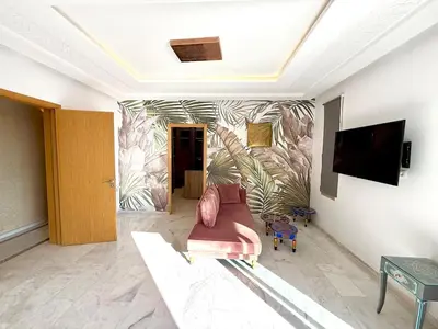 a living room with a couch and a wall at Luxury Villa with Private XXL Pool in Azib Oulad Lâdem