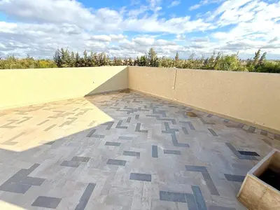 a balcony with a tile floor and a wall at Luxury Villa with Private XXL Pool in Azib Oulad Lâdem