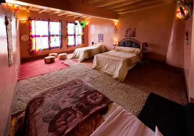 a bedroom with two beds in a room at Kasbah Anizir Itran in Kalaat MGouna