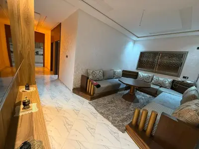 a living room with a couch and a table at Modern and friendly apartment in Azrou