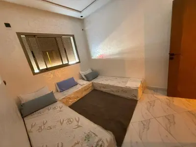 a room with two beds and a window at Modern and friendly apartment in Azrou