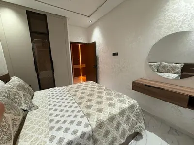 a bedroom with a bed and a large mirror at Modern and friendly apartment in Azrou