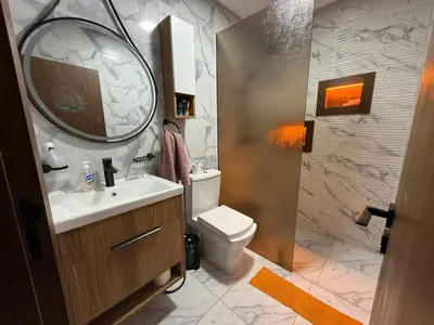 a bathroom with a sink and a toilet and a mirror at Modern and friendly apartment in Azrou