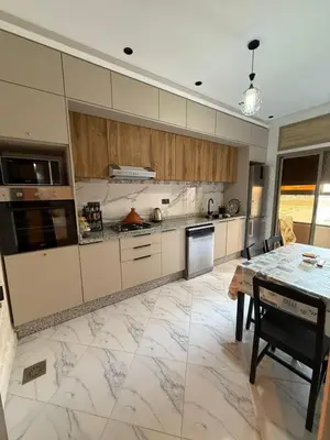 a kitchen with a table and a counter top at Modern and friendly apartment in Azrou
