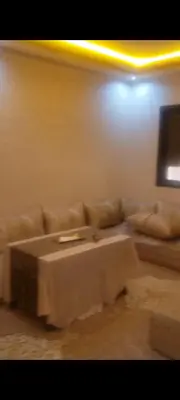 a living room with a couch and a table at mina residence