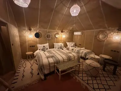 a room with four beds in a tent at merzouga best luxury camp in Merzouga