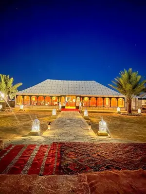 a large building with a pathway leading to it at merzouga best luxury camp in Merzouga