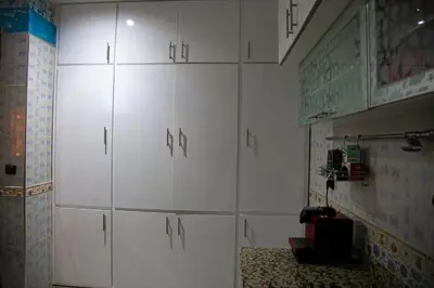 a room with white cabinets with letters on them at Nise Apartment in Oulad Akkou