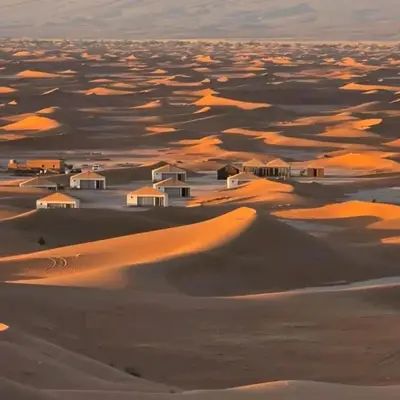 a desert with houses on top of sand dunes at M'hamid El Ghizlane, Provinz Zagora in Oulad Akkou