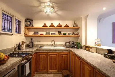 a kitchen with a sink and a counter top at Riad Tiklit in Oulad Akkou