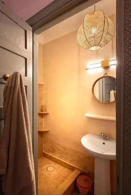 a bathroom with a sink and a mirror at Riad Tiklit in Oulad Akkou