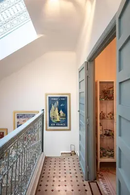a hallway with a staircase with a blue door at Riad Tiklit in Oulad Akkou