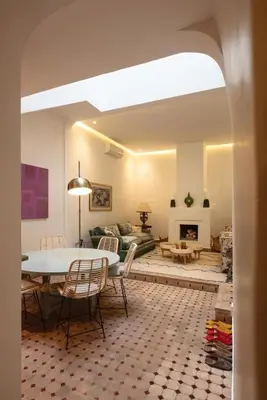 a living room with a table and a couch at Riad Tiklit in Oulad Akkou