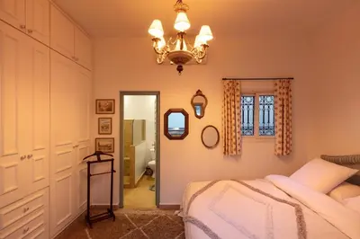 a bedroom with a bed and a chandelier at Riad Tiklit in Oulad Akkou