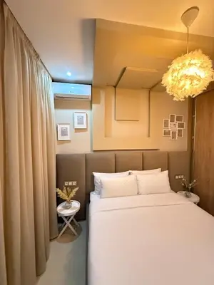 a bedroom with a large bed and a chandelier at modern family stay in Meknès