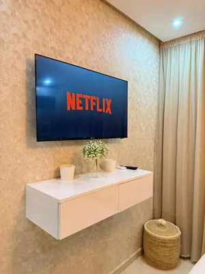 a television on a wall with a netflix at modern family stay in Meknès