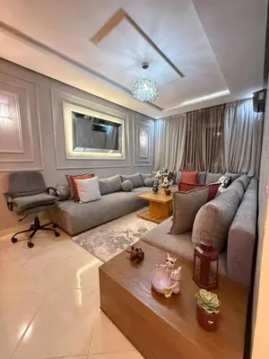 a living room with a couch and a table at modern family stay in Meknès
