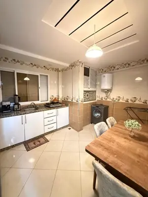 a large kitchen with a table and a table sidx sidx sidx at modern family stay in Meknès