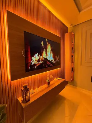 a living room with a tv on a wall at modern family stay in Meknès