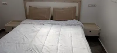a bed in a room with two nightstands and sidx sidx sidx at Appartement Fès standing in Fès